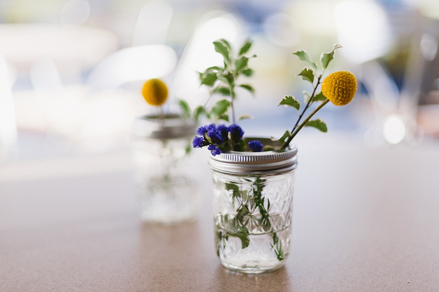 A mason jar centerpiece with a Billy Ball flower