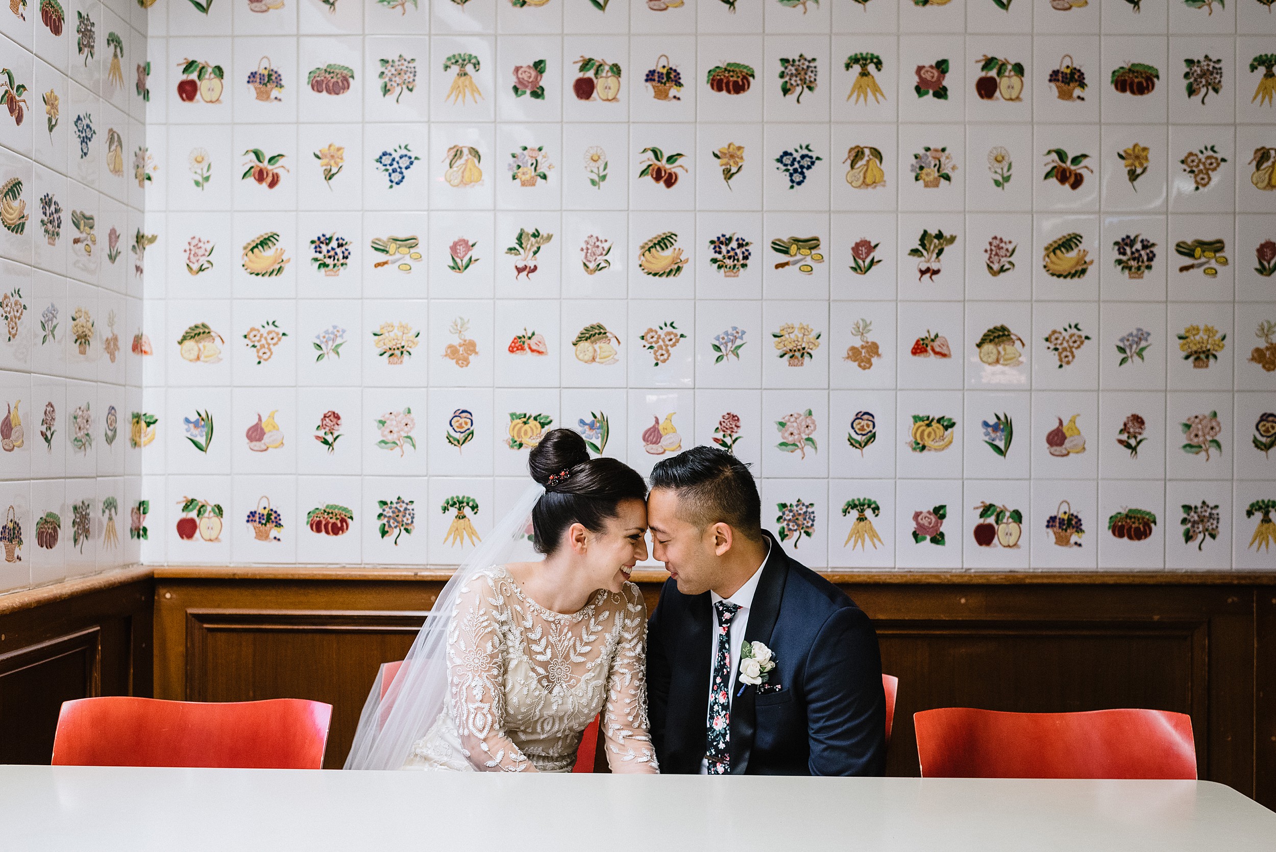 portrait in front of fruit tile