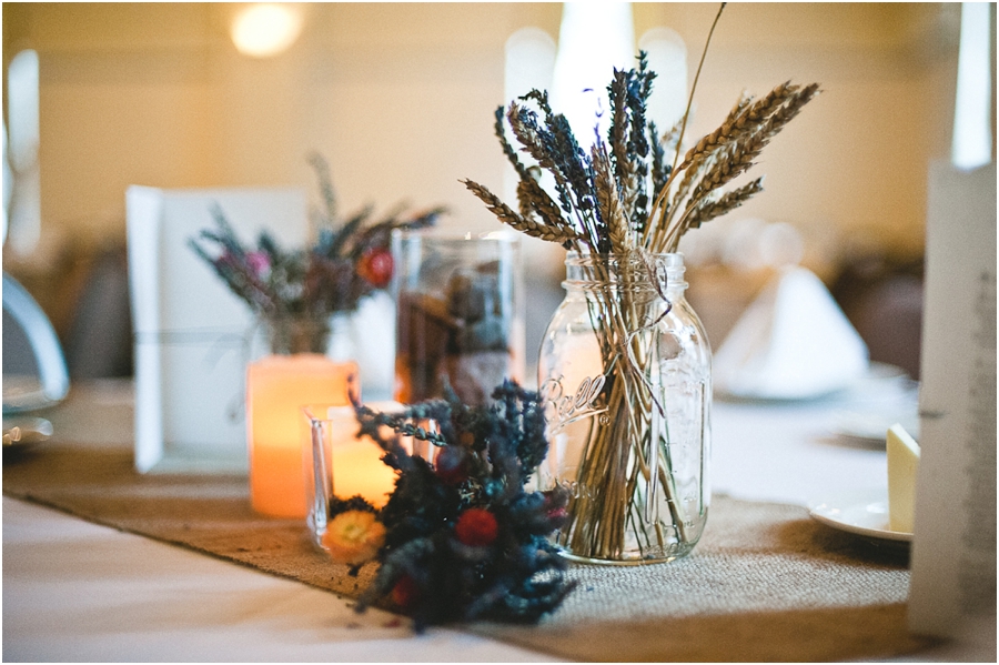Dry flowers in mason jars reception centerpieces.